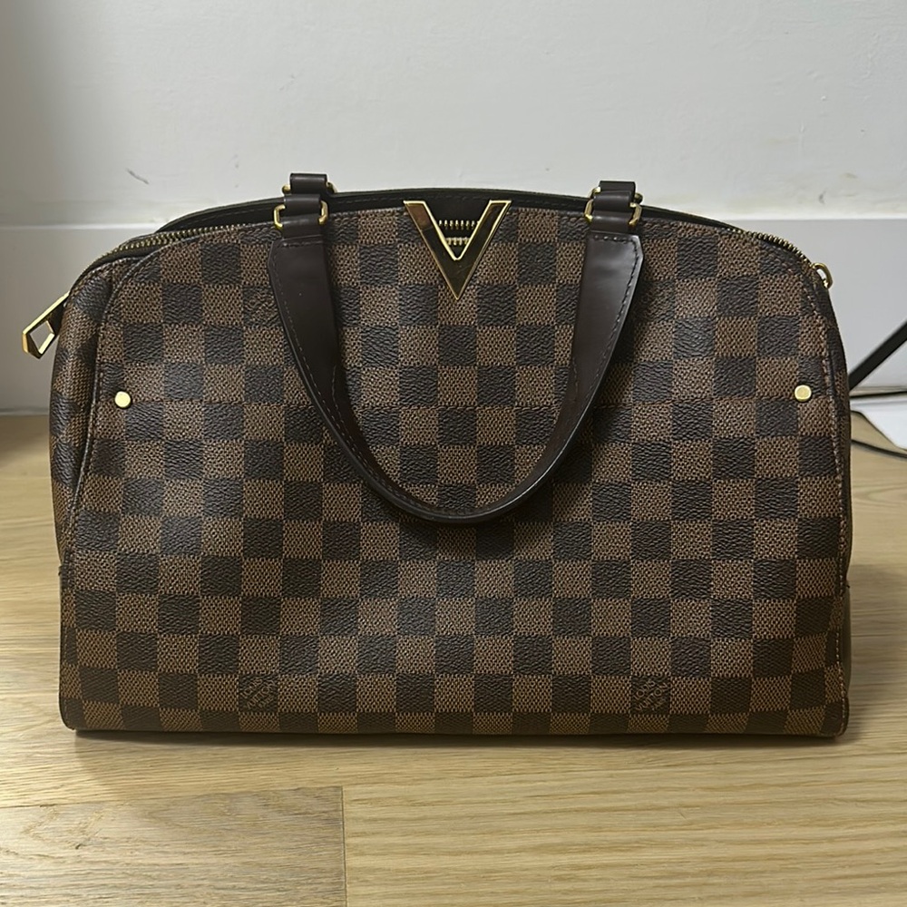Louis Vuitton bag with top handle and long strap